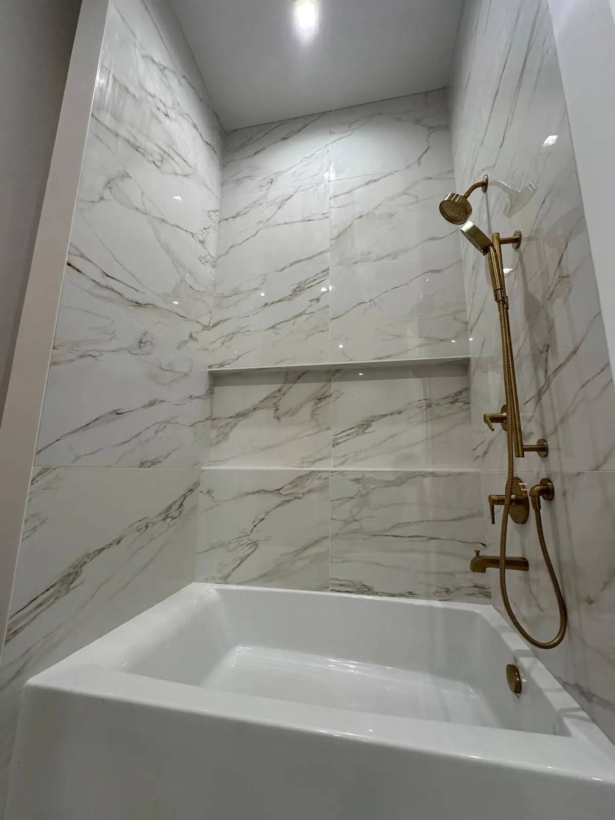Custom bathroom tile installation with modern fixtures